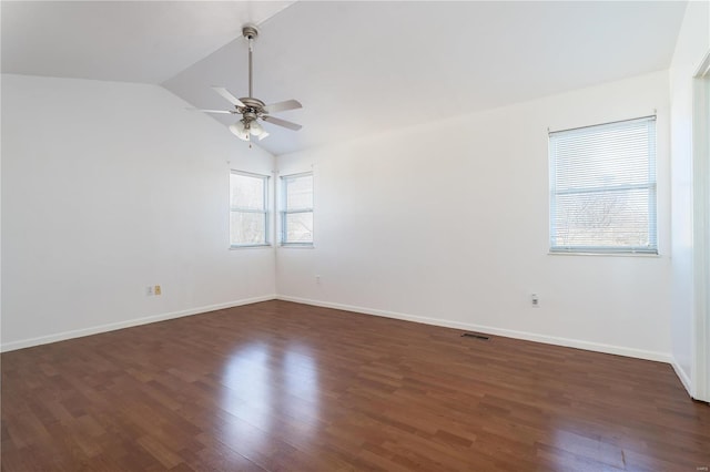 unfurnished room with a ceiling fan, dark wood-style floors, vaulted ceiling, and baseboards