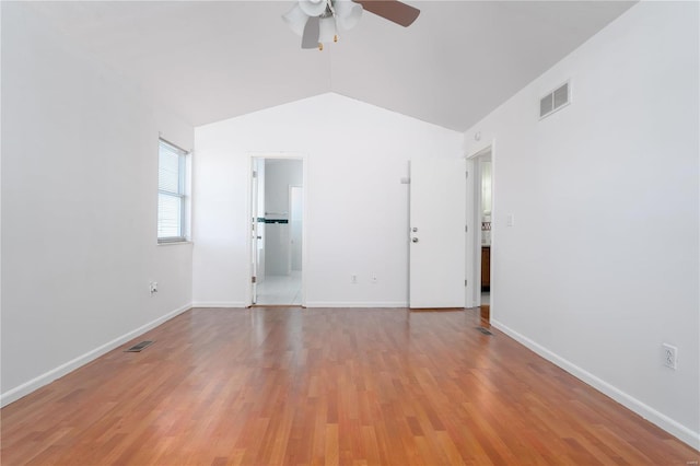 unfurnished room with ceiling fan, lofted ceiling, light wood-style floors, and baseboards
