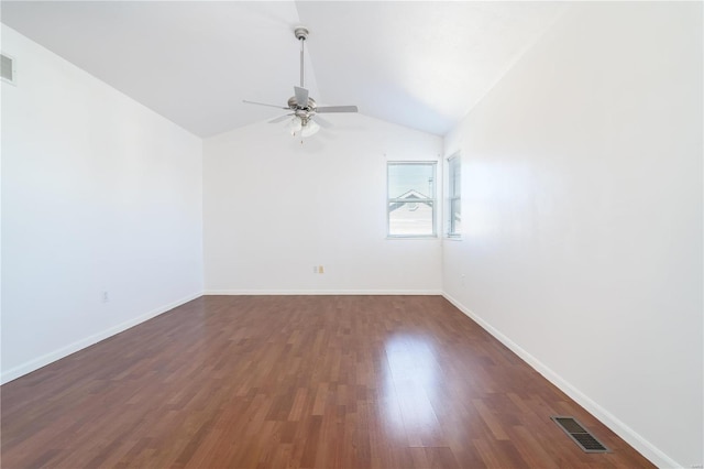 unfurnished room with a ceiling fan, dark wood finished floors, vaulted ceiling, and baseboards