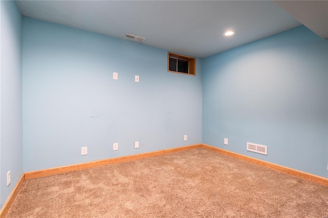 carpeted empty room featuring baseboards and recessed lighting