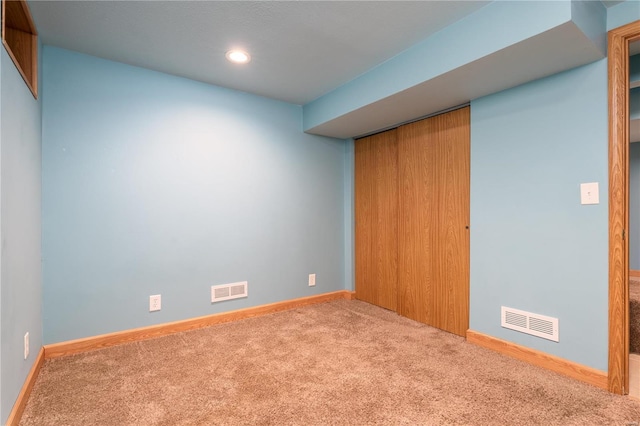 spare room featuring carpet flooring, baseboards, and recessed lighting