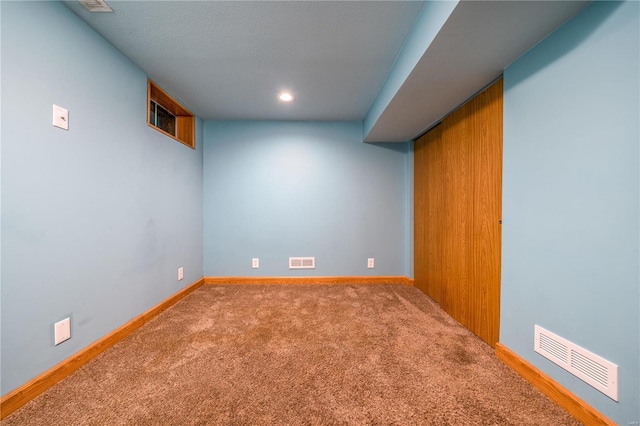 finished below grade area with carpet floors, baseboards, and recessed lighting