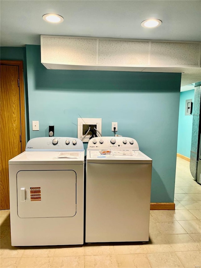 laundry room with washer and dryer and baseboards