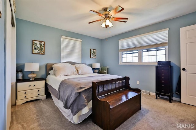 carpeted bedroom with baseboards and a ceiling fan