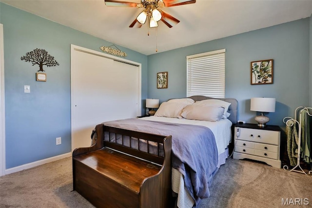 bedroom with carpet flooring, baseboards, a closet, and ceiling fan
