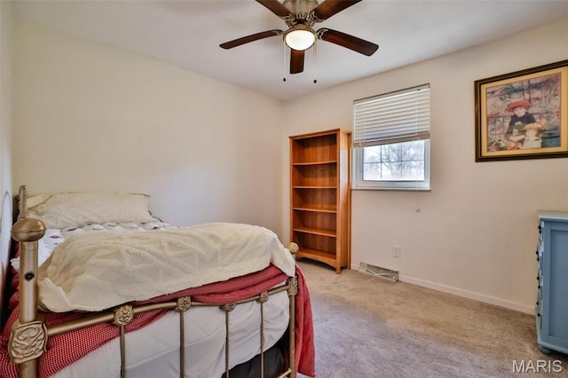 carpeted bedroom with baseboards and a ceiling fan