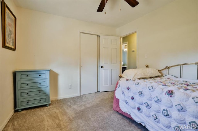 carpeted bedroom featuring a closet, a ceiling fan, and baseboards