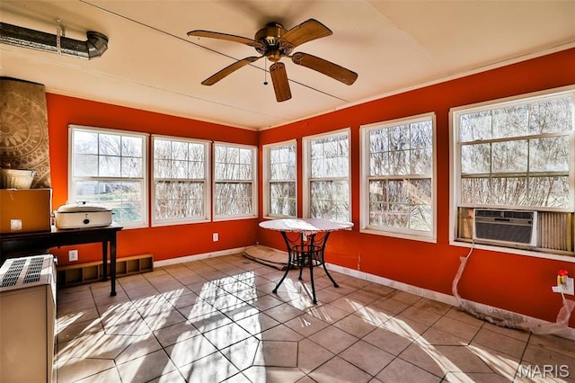 sunroom featuring healthy amount of natural light, tile patterned flooring, cooling unit, lofted ceiling, and baseboards