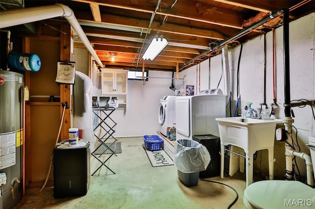 unfinished below grade area featuring washing machine and clothes dryer and water heater