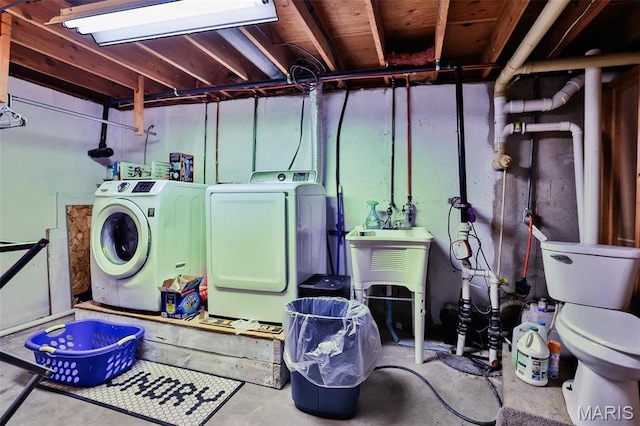 clothes washing area featuring independent washer and dryer