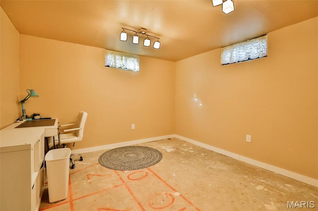 unfurnished office featuring baseboards