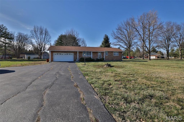 ranch-style house with an attached garage, driveway, brick siding, and a front yard