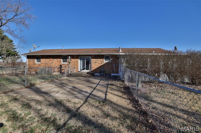 rear view of house featuring a fenced backyard and a patio