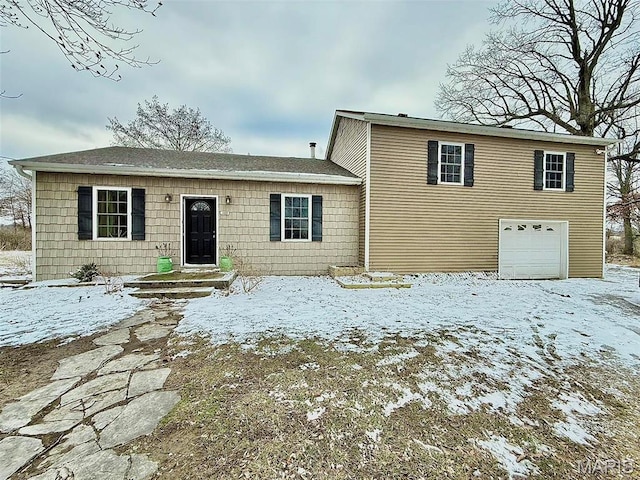 view of front of home featuring a shingled roof and a garage