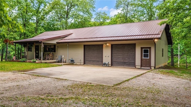 3153 N 2225th, Beecher City, IL 62414 - view of front of house with metal roof, covered porch, and an attached garage