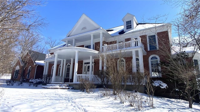 821 Oak Knoll Rd, Rolla, MO 65401 - greek revival house featuring a balcony, brick siding, and covered porch