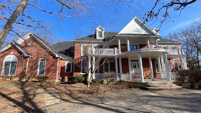 821 Oak Knoll Rd, Rolla, MO 65401 - neoclassical / greek revival house featuring a balcony, a porch, and brick siding