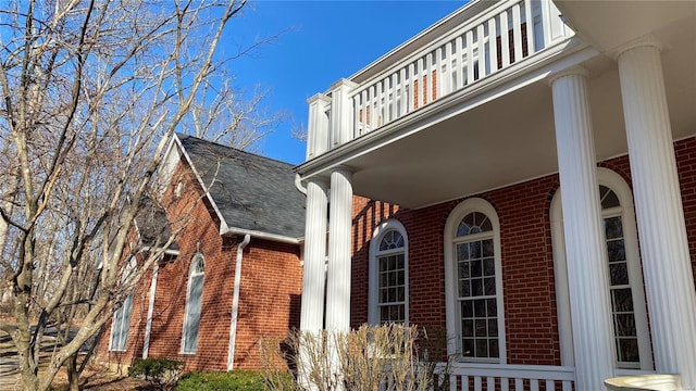 821 Oak Knoll Rd, Rolla, MO 65401 - view of home's exterior featuring brick siding, a shingled roof, and a balcony