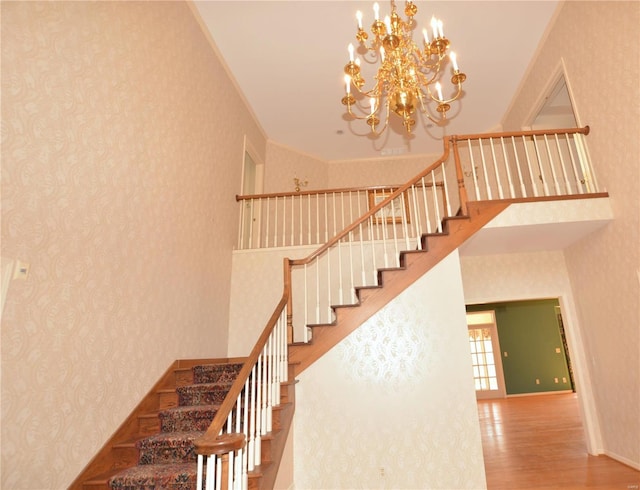 821 Oak Knoll Rd, Rolla, MO 65401 - stairway featuring wood finished floors, a chandelier, and a towering ceiling