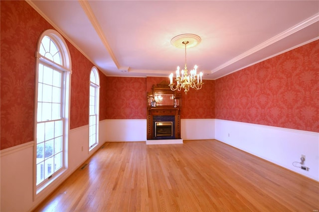 821 Oak Knoll Rd, Rolla, MO 65401 - unfurnished living room featuring a wainscoted wall, light wood finished floors, a chandelier, healthy amount of natural light, and wallpapered walls