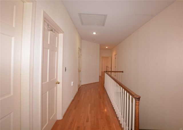 821 Oak Knoll Rd, Rolla, MO 65401 - hallway with an upstairs landing, light wood-style flooring, and recessed lighting
