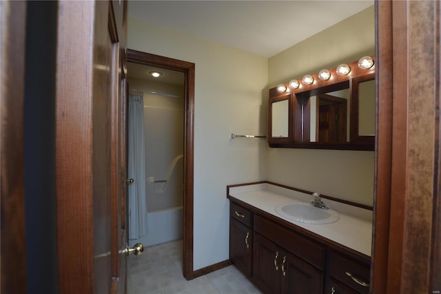 821 Oak Knoll Rd, Rolla, MO 65401 - bathroom with vanity, bathtub / shower combination, and baseboards
