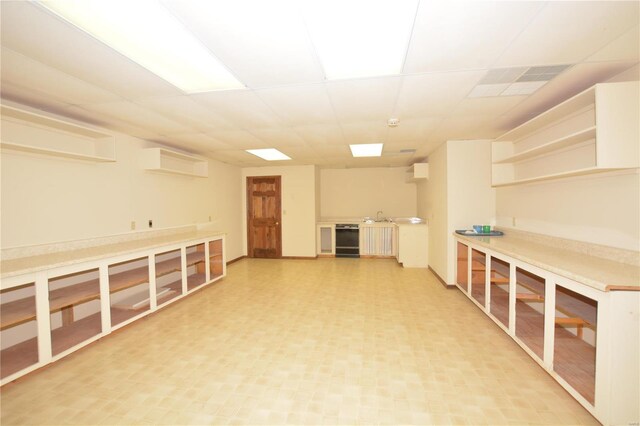 821 Oak Knoll Rd, Rolla, MO 65401 - basement with a paneled ceiling, an AC wall unit, light floors, and beverage cooler