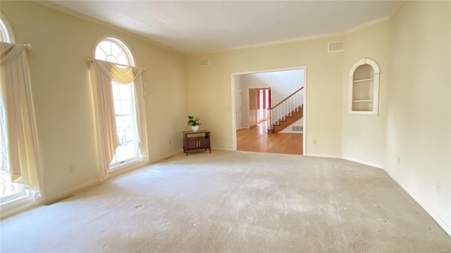 821 Oak Knoll Rd, Rolla, MO 65401 - carpeted empty room featuring crown molding, stairway, and baseboards