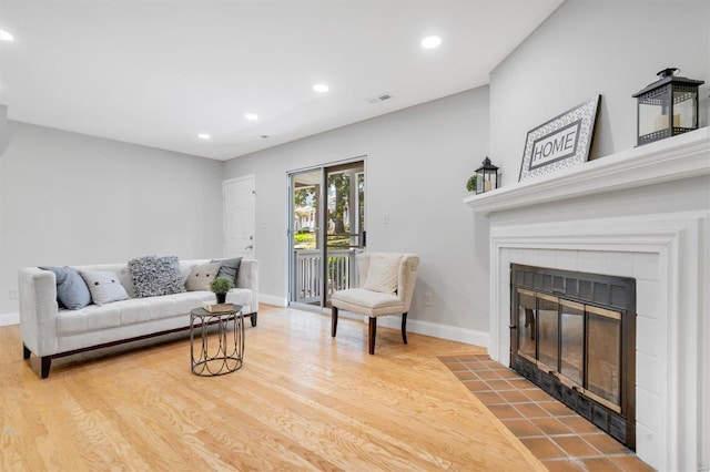 1418 Bluebird Ter, Saint Louis, MO 63144 - living room featuring a fireplace, wood finished floors, recessed lighting, and baseboards