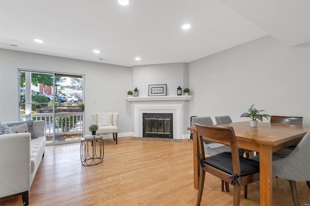 1418 Bluebird Ter, Saint Louis, MO 63144 - dining space featuring a fireplace, light wood-style floors, and recessed lighting