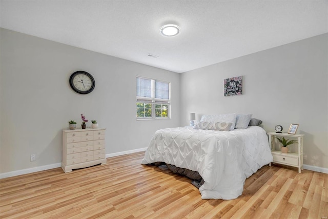 1418 Bluebird Ter, Saint Louis, MO 63144 - bedroom with light wood-style flooring and baseboards