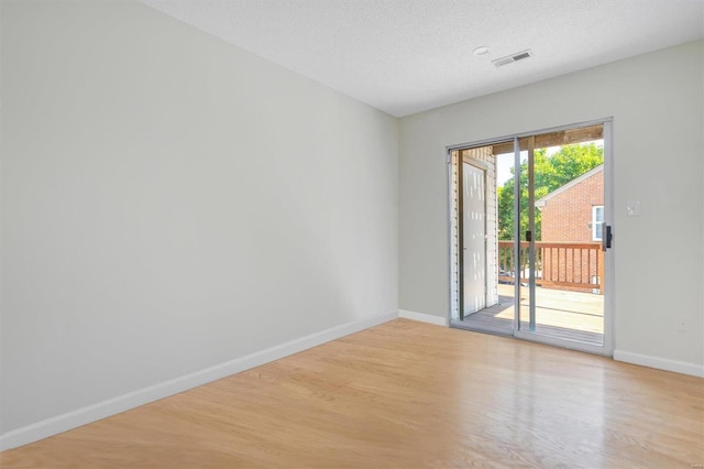 1418 Bluebird Ter, Saint Louis, MO 63144 - spare room with light wood-style floors, baseboards, and a textured ceiling