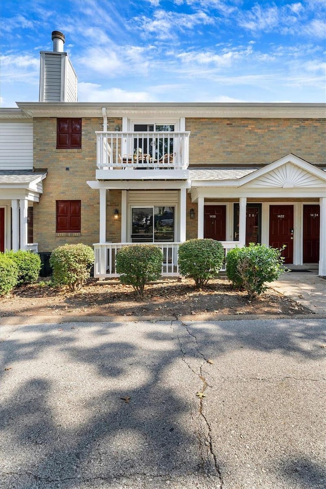 1418 Bluebird Ter, Saint Louis, MO 63144 - view of front of property with a balcony, a chimney, brick siding, and covered porch