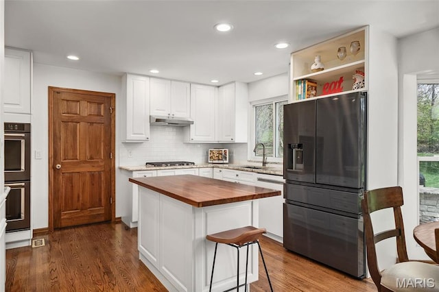 1578 Mason Knoll Rd, Town And Country, MO 63131 - kitchen featuring fridge with ice dispenser, butcher block counters, dishwashing machine, under cabinet range hood, and double oven