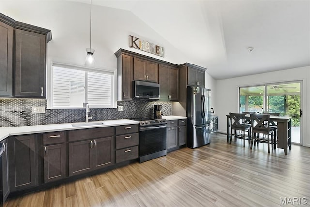 429 Arbor Meadow Ct, Ballwin, MO 63021 - kitchen with appliances with stainless steel finishes, a sink, light countertops, dark brown cabinetry, and tasteful backsplash