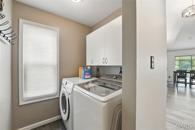 429 Arbor Meadow Ct, Ballwin, MO 63021 - laundry area featuring independent washer and dryer, cabinet space, light wood finished floors, and baseboards