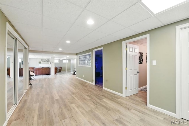 429 Arbor Meadow Ct, Ballwin, MO 63021 - unfurnished living room featuring light wood-type flooring, baseboards, a drop ceiling, and recessed lighting