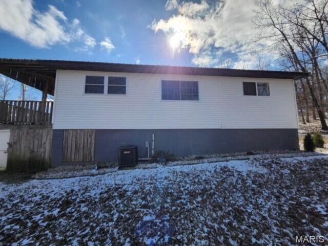 11498 M-Weatherman Dr, Mountain Grove, MO 65711 - snow covered rear of property with central AC