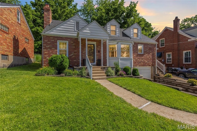 7603 Devonshire Ave, Shrewsbury, MO 63119 - view of front of home with brick siding, a front yard, and a garage