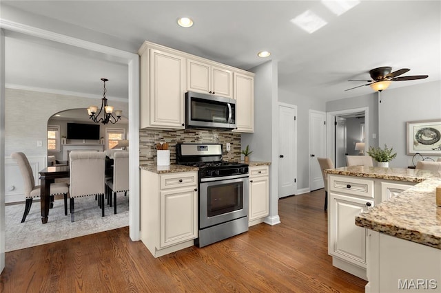 7603 Devonshire Ave, Shrewsbury, MO 63119 - kitchen featuring stainless steel appliances, a chandelier, dark wood-style floors, light stone counters, and recessed lighting