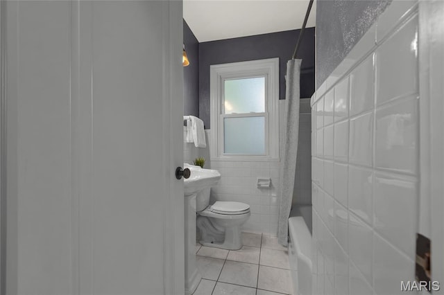7603 Devonshire Ave, Shrewsbury, MO 63119 - bathroom with tile patterned floors, toilet, tile walls, and shower / tub combo with curtain