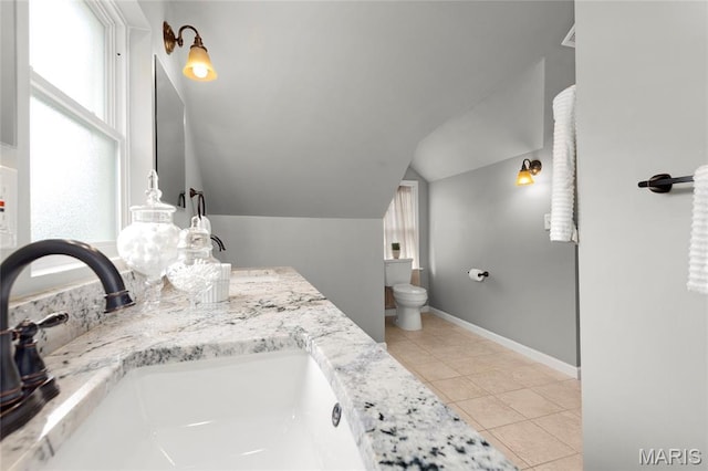 7603 Devonshire Ave, Shrewsbury, MO 63119 - full bath with vaulted ceiling, tile patterned floors, double vanity, toilet, and baseboards