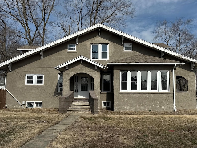 view of front of property featuring stucco siding and a shingled roof