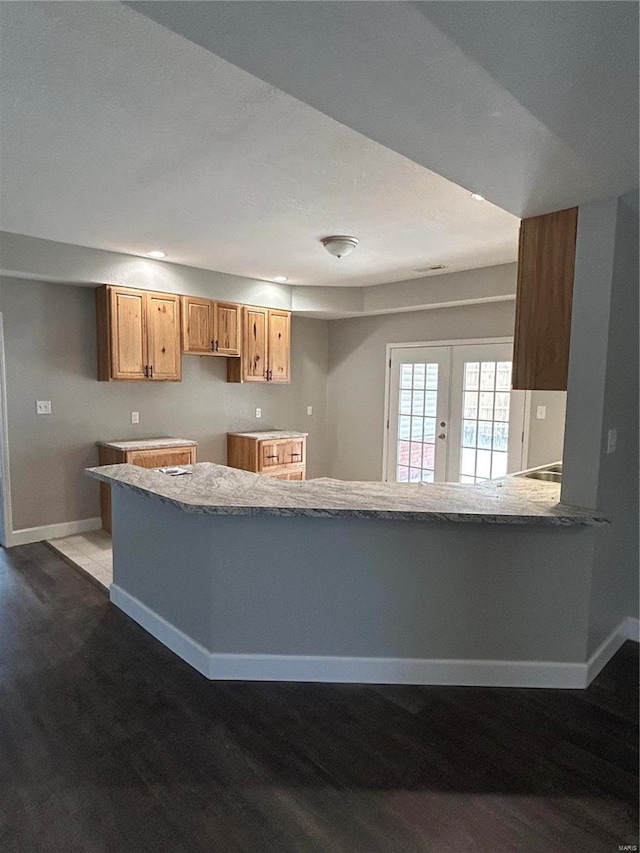 404 N Everett St, Kennett, MO 63857 - kitchen with baseboards, wood finished floors, french doors, and a peninsula