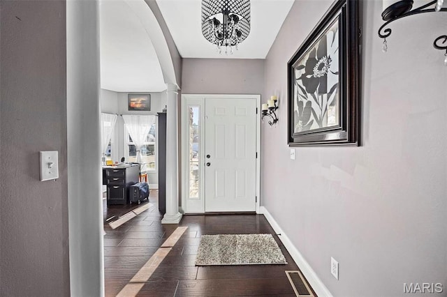 4028 Montague Cir Unit 4, Saint Charles, MO 63304 - foyer entrance featuring decorative columns, wood-type flooring, baseboards, and arched walkways