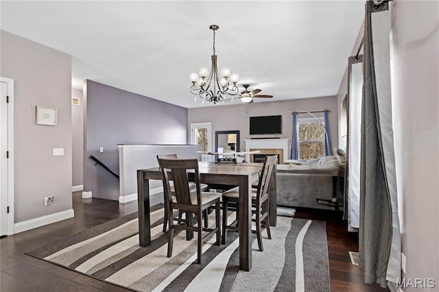 4028 Montague Cir Unit 4, Saint Charles, MO 63304 - dining area featuring wood finished floors, a chandelier, baseboards, a fireplace, and ceiling fan