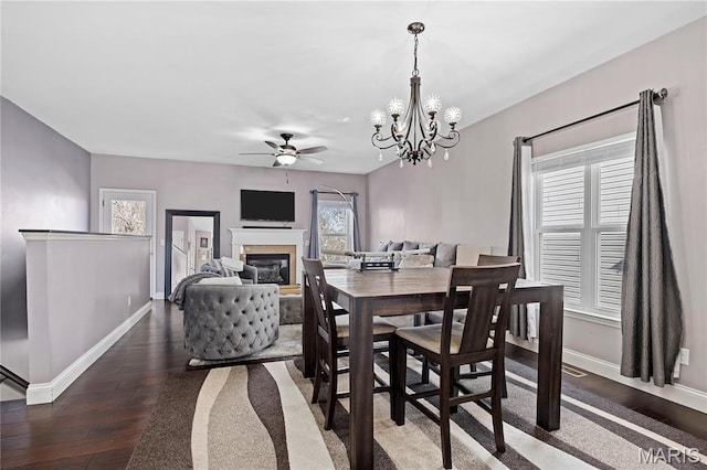 4028 Montague Cir Unit 4, Saint Charles, MO 63304 - dining area featuring baseboards, wood-type flooring, a ceiling fan, a glass covered fireplace, and a chandelier