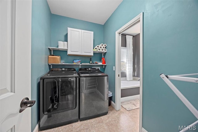 4028 Montague Cir Unit 4, Saint Charles, MO 63304 - laundry room featuring washing machine and clothes dryer, cabinet space, and baseboards