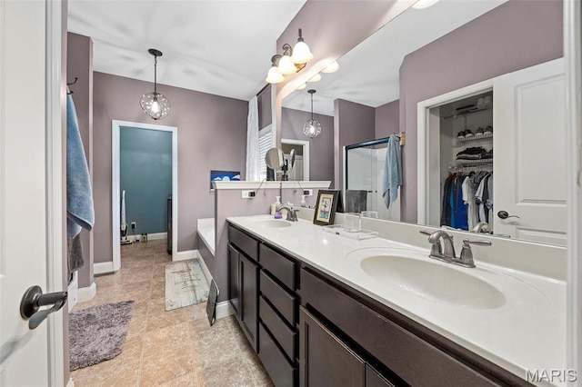 4028 Montague Cir Unit 4, Saint Charles, MO 63304 - full bathroom with baseboards, a walk in closet, a shower stall, and double vanity