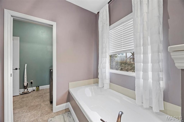 4028 Montague Cir Unit 4, Saint Charles, MO 63304 - full bath featuring a garden tub and baseboards